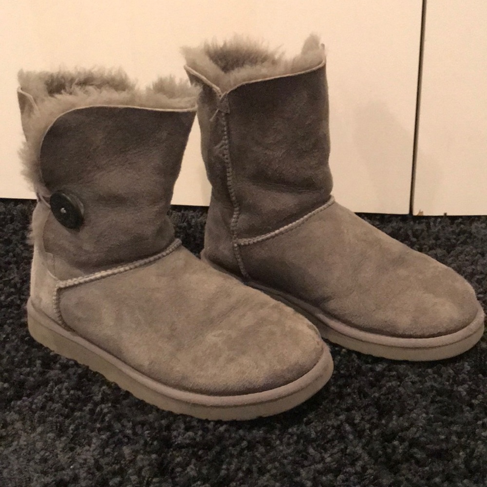 Grey UGG boots with a button on the side